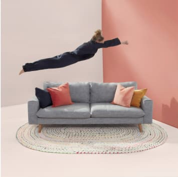 Girl jumping onto couch