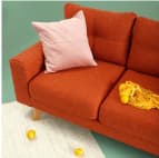 Red couch with pink pillow